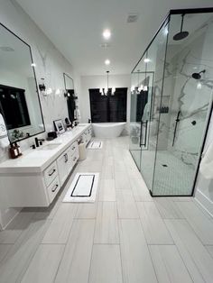 a large bathroom with two sinks and a walk in shower