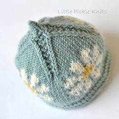 a knitted ball sitting on top of a white table