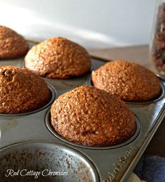 several muffins in a metal pan on a table