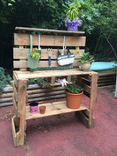 a potted plant sitting on top of a wooden shelf next to a bench filled with plants