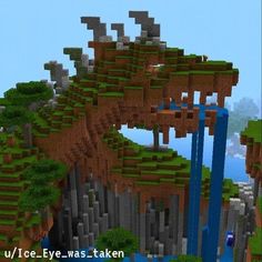 an image of a mountain with trees and rocks in the foreground that is minecraft