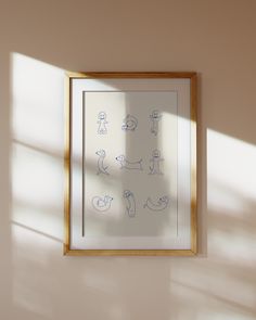 a framed drawing hangs on the wall next to a window with light coming through it