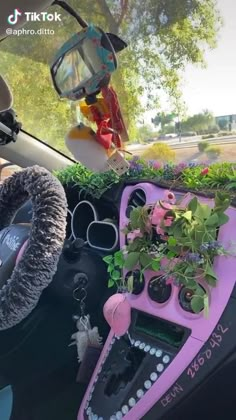 the interior of a car is decorated with plants and other things that are sitting on the dashboard