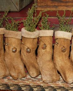 five brown socks with plants in them sitting on a shelf next to a fireplace mantel