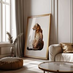 a framed photograph of a leopard sitting on the floor next to a couch and coffee table