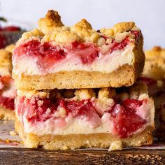 three pieces of strawberry crumb bars stacked on top of each other with one slice cut out