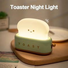 toaster night light is sitting on top of a cutting board with the words toast