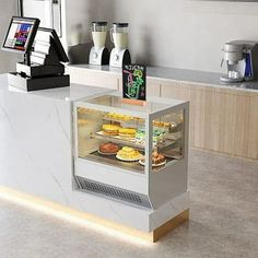 a display case in the middle of a kitchen filled with pastries and desserts