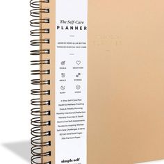 the self - care planner is open with spirals