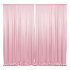 two pink curtains hanging on the side of a wall