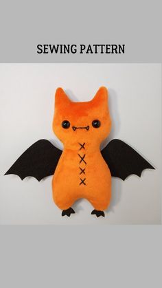 an orange stuffed animal with black wings and stitches on it's chest, sitting in front of the words sewing pattern