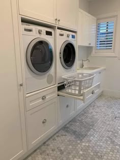 a washer and dryer in a white laundry room