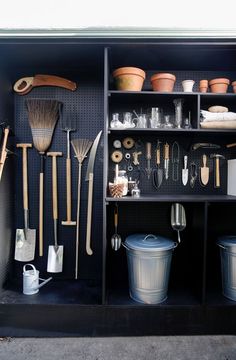 a shelf filled with lots of different types of gardening utensils and other items