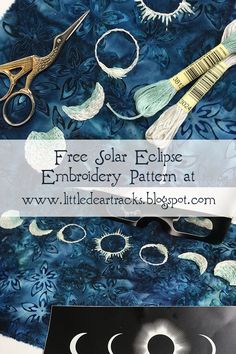 an image of some scissors and other items on a blue background with the words free solar eclipse embroidery pattern at www littlecartracks blog