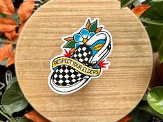 a sticker on top of a wooden table surrounded by leaves and flowers with the words respect wallpapers