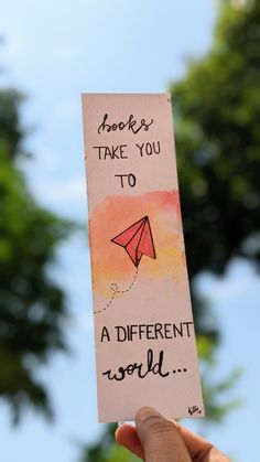 someone is holding up a card that says, books take you to a different world