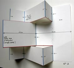 two bookshelves made out of white paper with blue and red lines