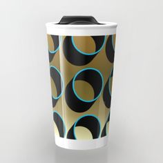 a coffee cup with blue and black circles on it