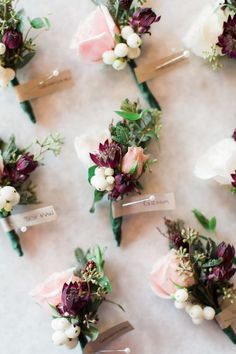 wedding boutonnieres are arranged on the table