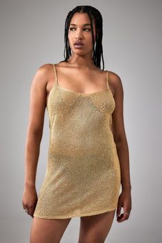 Party in your 90s-style mini dress topped with shimmery sequin details. Knitted slip dress Ft. a scoop neck, adjustable skinny straps and a mini hem, complete with stitched sequins throughout. Content + Care 95% Polyester, 5% Metallicized fibres Machine wash Imported Size + Fit Model in Gold is 179cm/5'10.5" and wearing size Small Length: 79cm Measurements taken from a size Small | Urban Outfitters UO Alexa Sequin Knit 90s Mini Dress in Gold at Urban Outfitters 90s Mini Dress, Sequin Knit, 90s Style, 90s Fashion, Urban Outfitters, Fitness Models, Scoop Neck, Slip Dress, Sequin