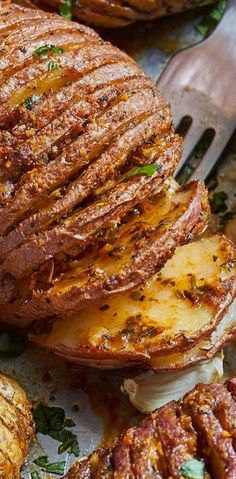 an image of some food on a plate with potatoes and meats in the background