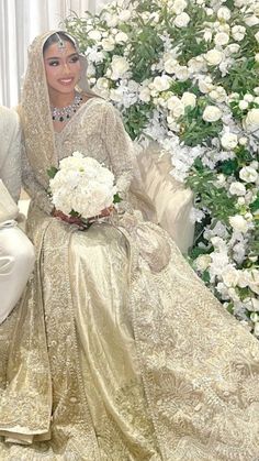 the bride and groom pose for a photo in front of a floral backdrop at their wedding