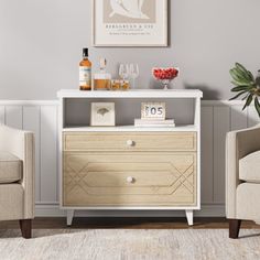 a living room with two chairs and a cabinet