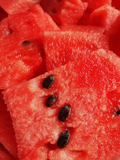 slices of watermelon and black seeds on top of each other in close up