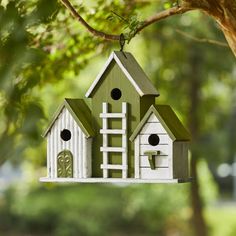 a bird house hanging from a tree branch