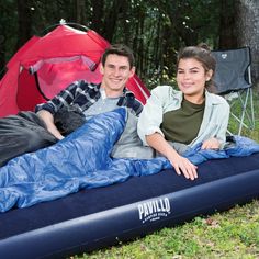 two people laying on an inflatable sleeping bag