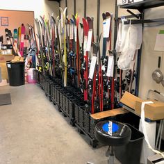 a room filled with lots of skis and snowboards