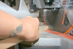 a person is working on a machine in a factory or shop with their arm tattooed