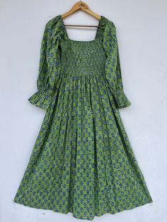 "block printed dress, hippie dress, vintage gown, floral dress, boho dresses, smocked maxi, long dress, long maxi, beautiful dresses, stylish maxi, unique dresses, indian cotton dresses seller, dresses with pockets, comfortable maxi, holiday wear dress, floral dress, block print dress, long maxi, cotton maxi, floral maxi, partywear dress, green maxi, bohemian dresses Feel beautiful and confident throughout your days wearing our block printed outfits, made with high quality soft and breathable cotton fabric.  The print on the dress is known as \"BLOCK PRINT\" which is centuries old technique of Indian textile carried out  by local artisans of Jaipur (INDIA) MEASUREMENTS (in inches): Size XXS-: Bust- 34″ | Shoulder- 13.5″ | Length- 51″ Size XS-: Bust- 36″ | Shoulder- 14″ | Length- 51″ Size S Green Bohemian Maxi Dress With Smocked Back, Bohemian Green Maxi Dress With Smocked Back, Fitted Bohemian Maxi Dress With Smocked Bodice, Bohemian Smocked Midi Dress, Bohemian Smocked Maxi Dress With Cuffs, Green Bohemian Dress With Smocked Back, Bohemian Smocked Maxi Dress With Smocked Cuffs, Bohemian Maxi Smocked Dress With Smocked Cuffs, Fitted Cotton Maxi Dress With Smocked Bodice