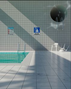 an empty swimming pool with chairs and signs