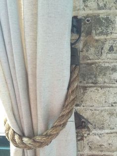 a rope wrapped around the top of a curtain