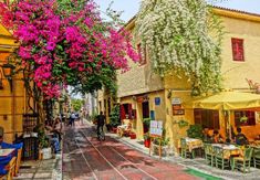 an empty street with tables and chairs on it