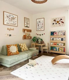 a living room filled with furniture and pictures on the wall