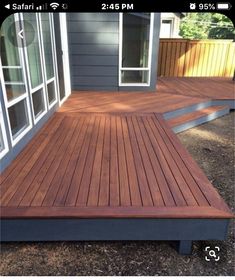 a wooden deck in front of a house