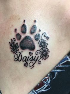 a dog's paw with flowers and hearts on the side of his chest that says, daisy