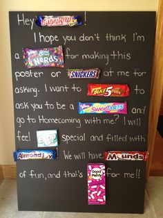 a chalkboard with candy bars on it and writing on the board in front of it