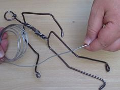 a person is holding a wire in front of a jar