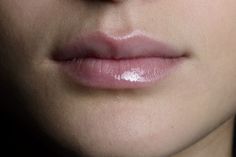 a woman's lips and nose are shown in close up