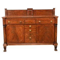 an old fashioned wooden dresser with brass handles