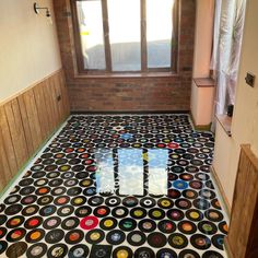 the floor is covered in many different colored circles and dots, as well as windows