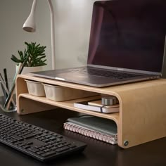 an open laptop computer sitting on top of a wooden desk next to a keyboard and mouse