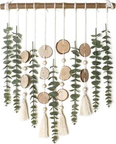 an image of a wind chime that is made out of wood and green leaves