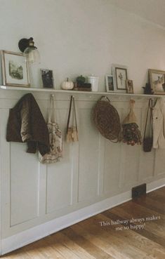 there are many purses hanging on the wall