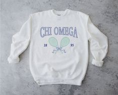 chi o is always the perfect match <3 ♡ Super soft sweatshirt comes in unisex sizing! Reference the size chart for additional details. It is recommended to SIZE UP for an oversized fit   ♡ Sweatshirt comes in white with a navy, blue and green print. Please check listing photos for color reference! ♡ Please make sure you are ordering for the correct sorority before placing an order! This listing is for CHI OMEGA. We are unable to accept returns or exchanges for this since all items are made to order.   ♡ INSTRUCTIONS FOR CARE:  1. Turn inside out before washing  2. Wash on a gentle cycle  3. Recommended not heat dry to prevent any minimal shrinking, hang to dry instead ♡ It is important that you LOVE your product! If you have any questions or concerns upon receiving your product, please cont Cotton Sorority Sweatshirt With Graphic Print, Cotton Sweatshirt With Graphic Print For Sorority, Sorority Long Sleeve Graphic Sweatshirt, Sorority Sweatshirt With Letter Print In Relaxed Fit, Sorority Graphic Print Long Sleeve Sweatshirt, Sorority Letter Print Sweatshirt In Relaxed Fit, Aesthetic Greek, Tennis Sweatshirt, Color Reference