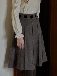 This product is an Autumn Grid Woolen Pleated Skirt, meticulously designed to showcase a blend of classic style with a preppy twist. The skirt features sharp pleats that provide a structured yet flowy movement, and it's accentuated with a detailed grid pattern that offers a textured visual appeal. It's finished with a clean waistband, enhancing the skirt's elegant form while ensuring a comfortable fit.This Autumn Grid Woolen Pleated Skirt boasts precise pleating, which creates a timeless, sophis Fall Office Mini Pleated Skirt, Classic Semi-formal Skirt For Fall, Classic Semi-formal Fall Skirt, Semi-formal Pleated Skirt For Fall, Semi-formal Flared Pleated Skirt, Classic A-line Pleated Skirt For Fall, Classic Formal Mini Pleated Skirt, Classic Pleated Skirt For Workwear In Fall, Fall Preppy Pleated Lined Skirt