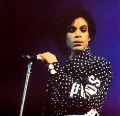 michael jackson on stage with microphone and polka dot shirt